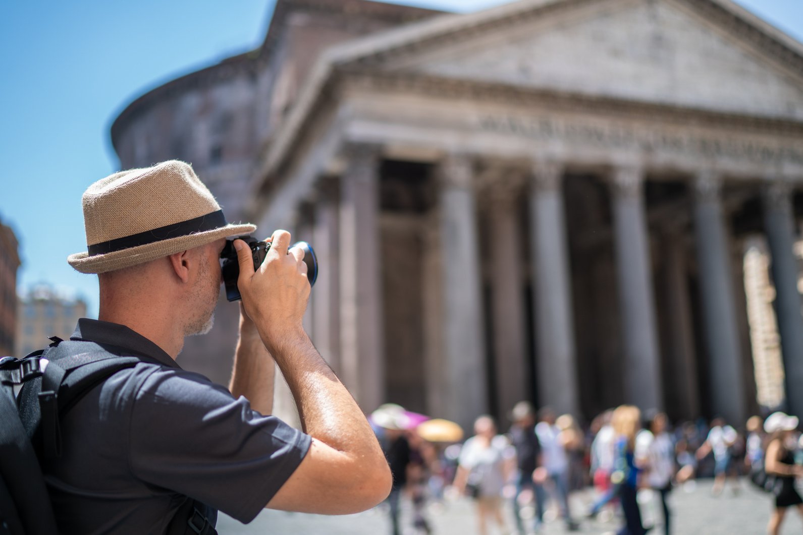 man during city break in Rome photographing pantheon